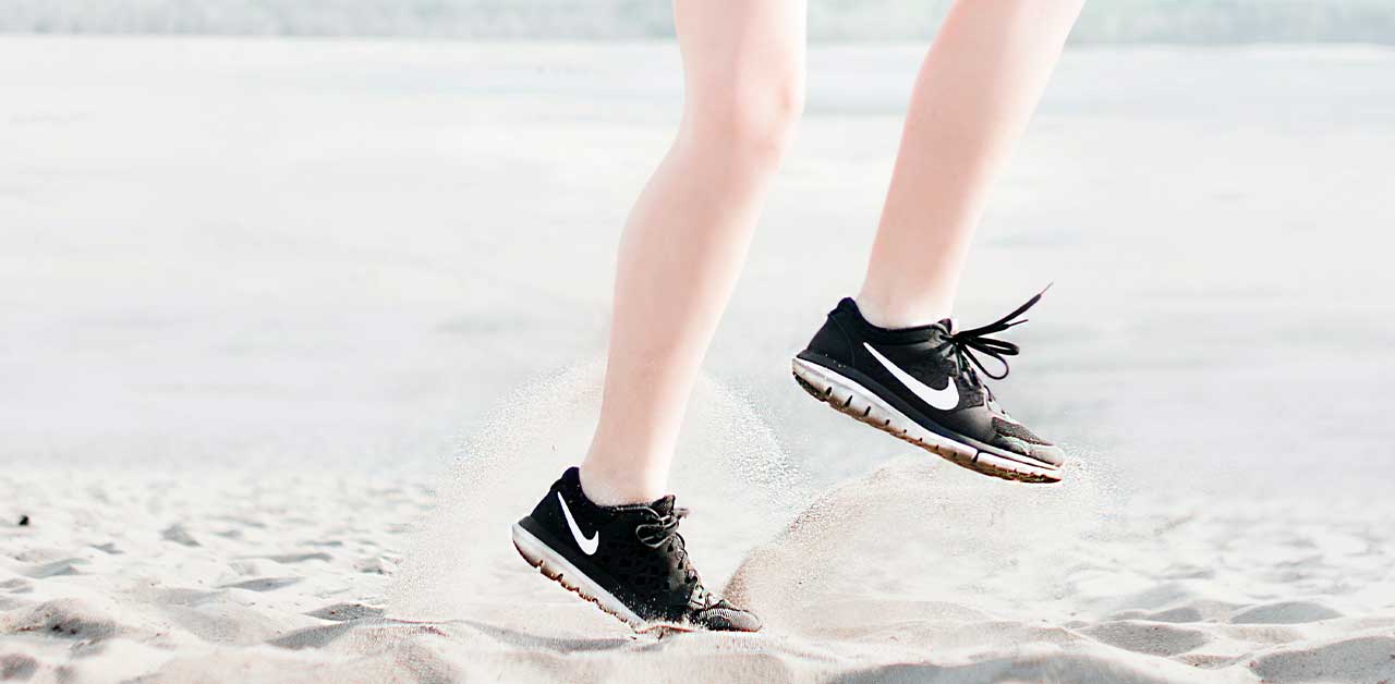 Person running on a beach in the summer