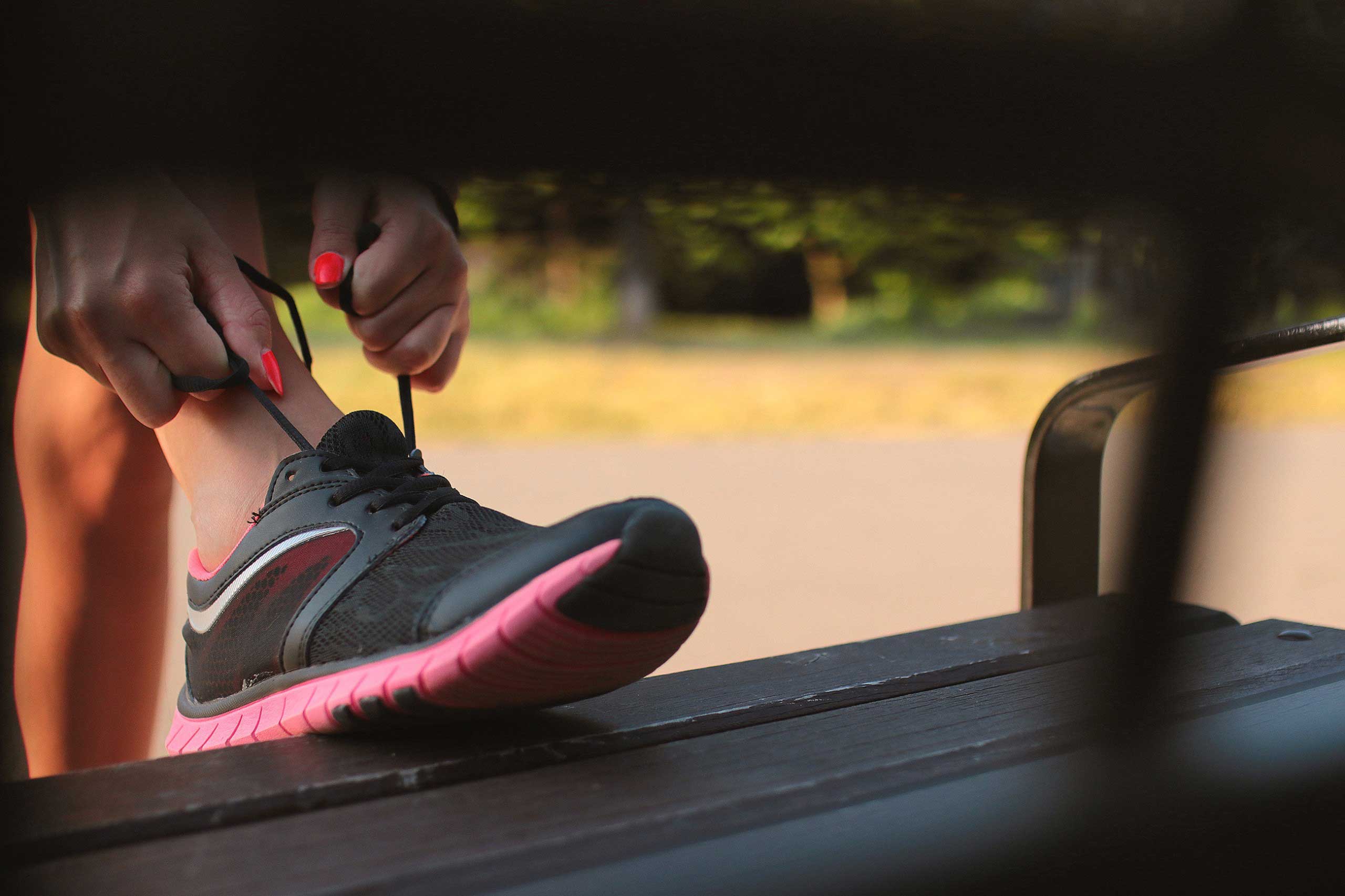 Woman tying laces on running shoes