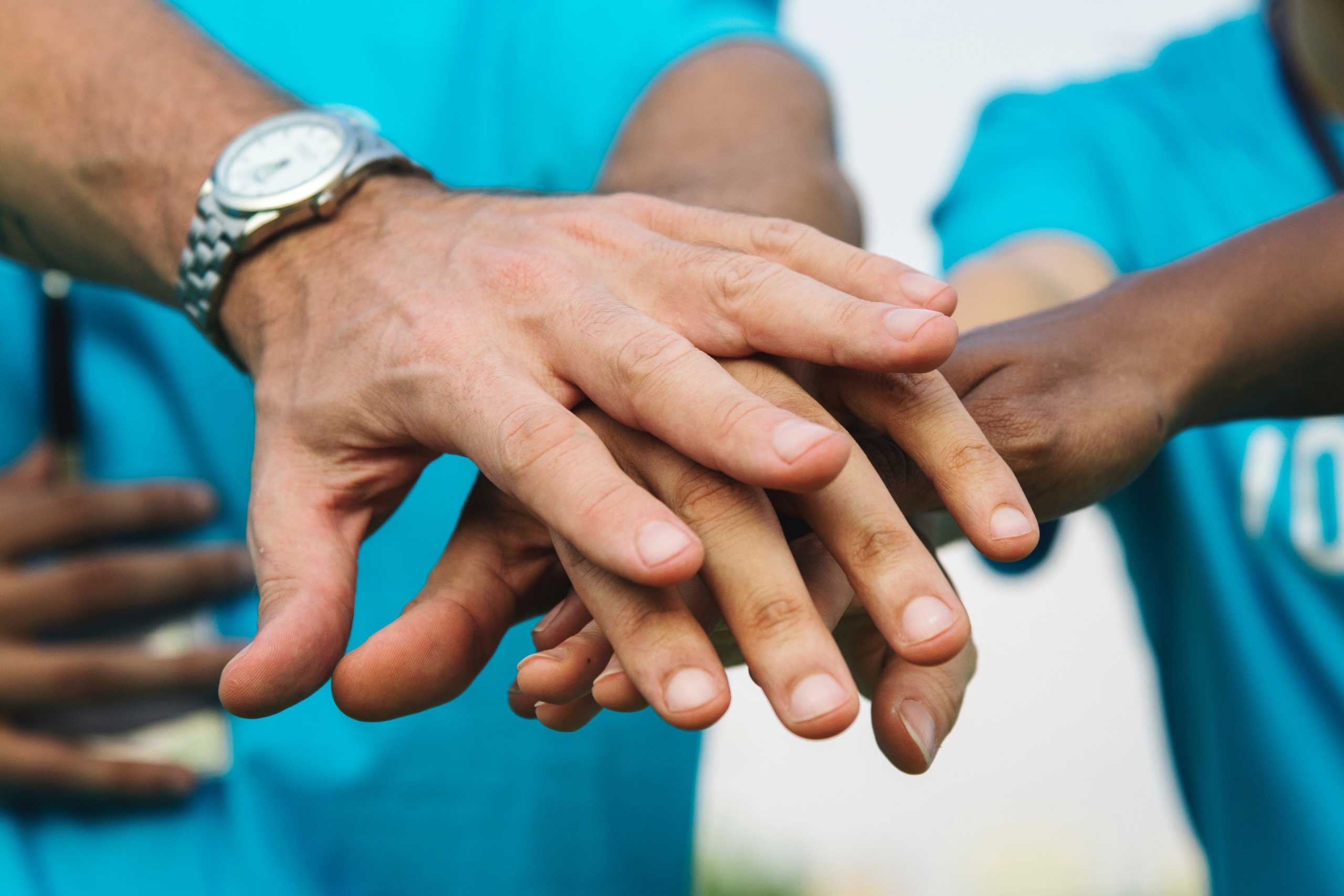 Group of people holding hands 