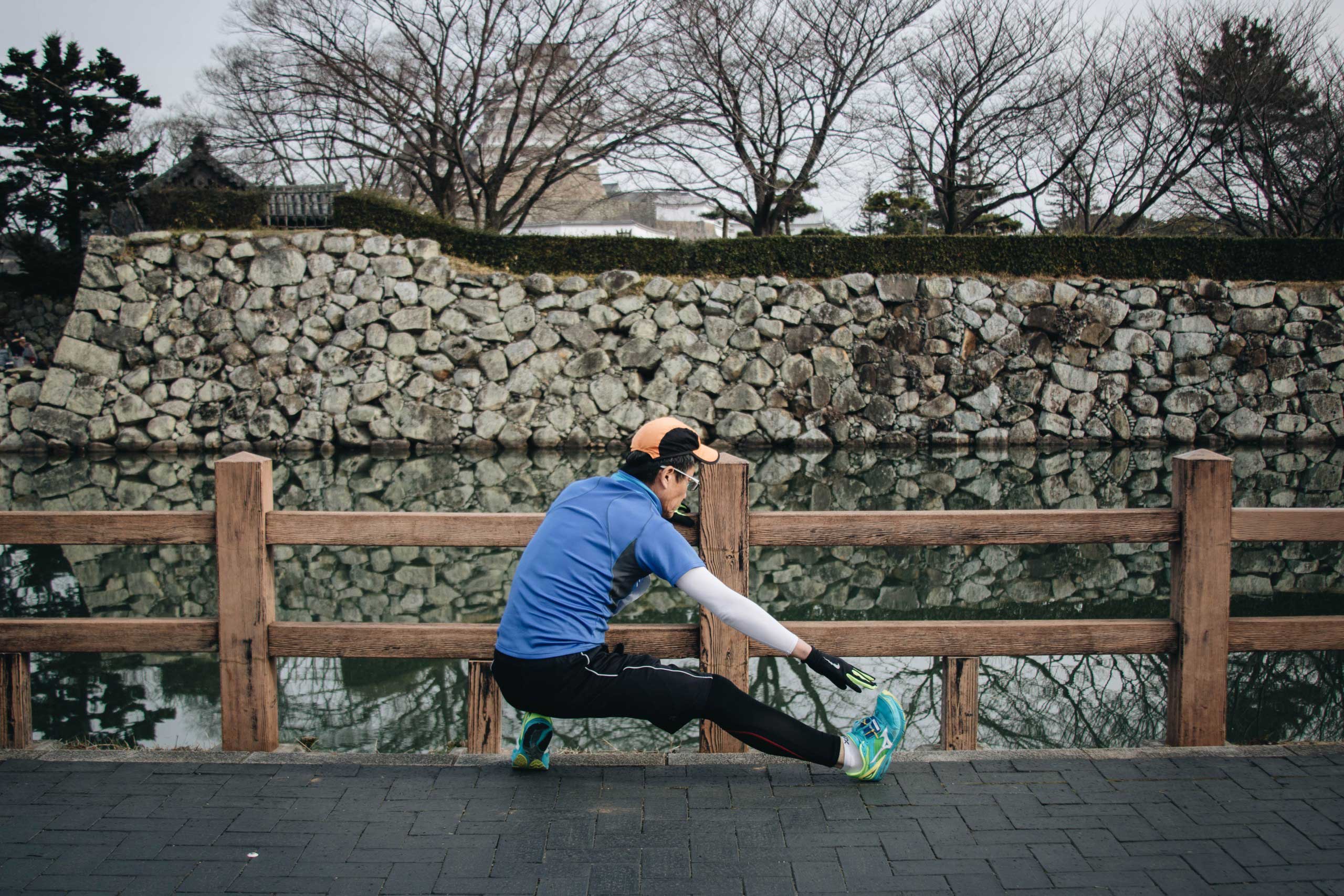 Man doing static stretches before running