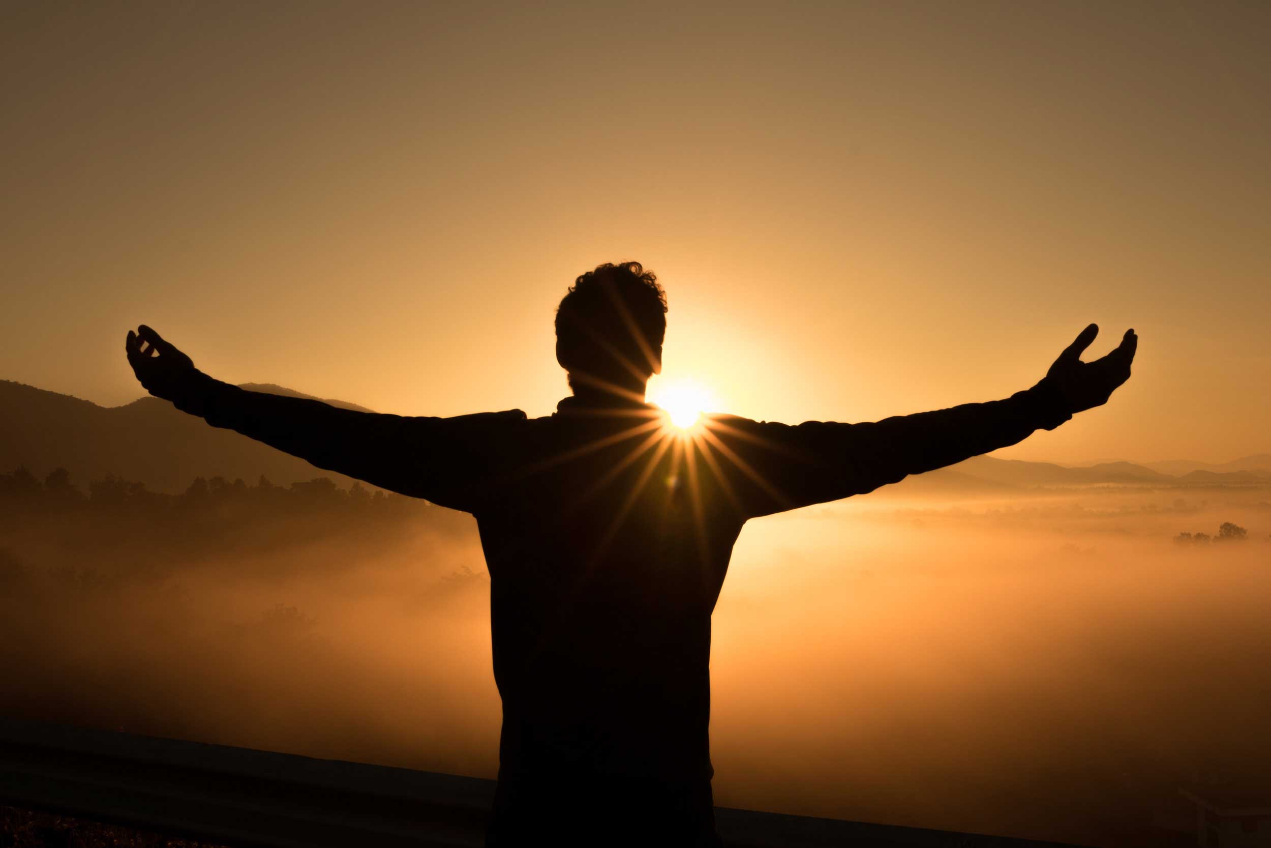 Man standing infront of sunrise