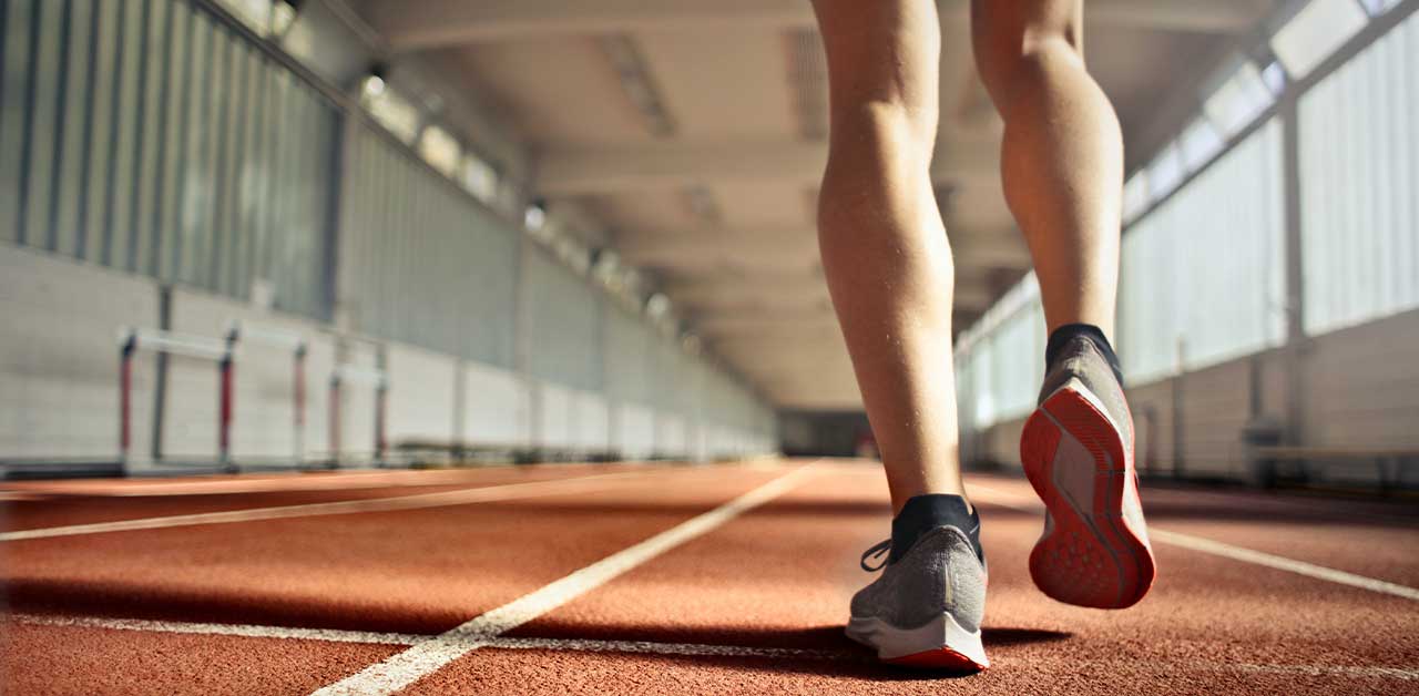 Person walking on an indoor running track