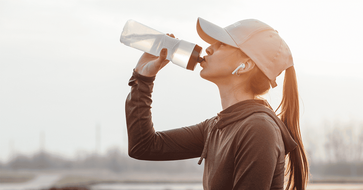 Runner drinking out of a water bottle